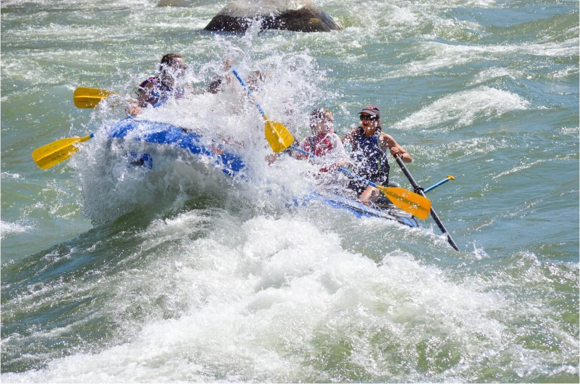 Group of people whitewater rafting on the Yellowstone River.